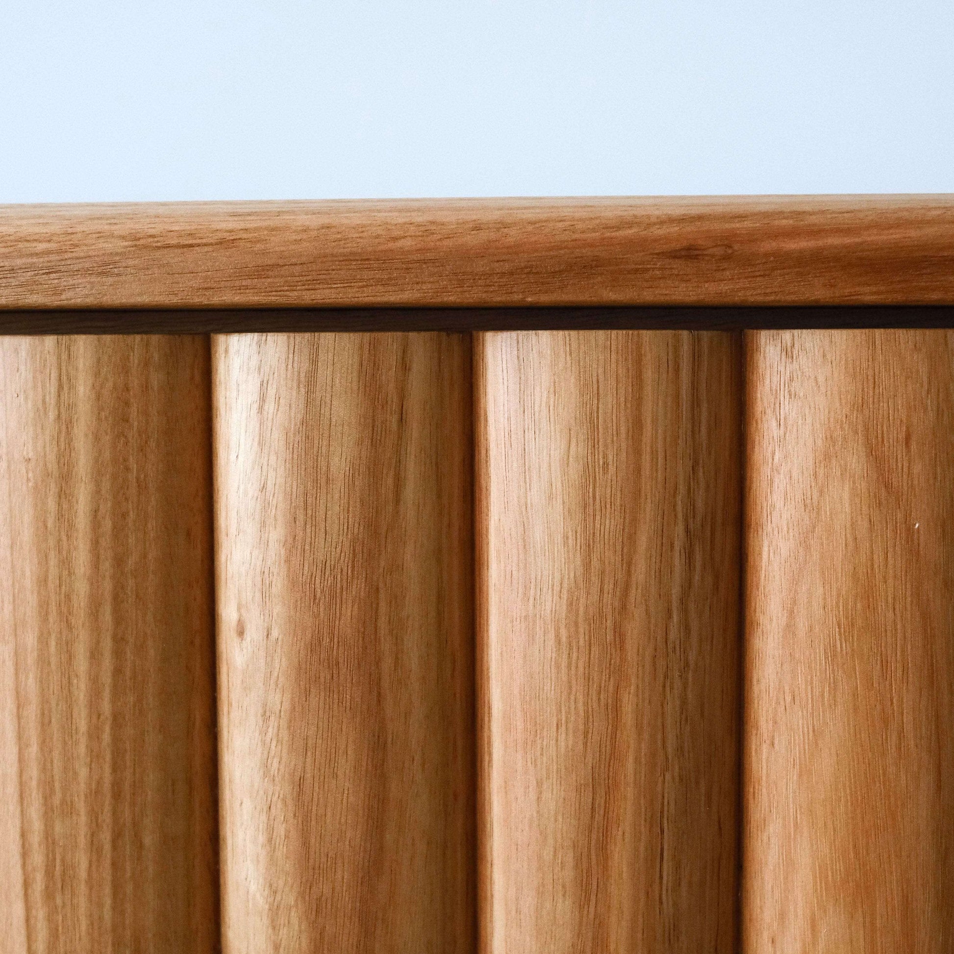 Close-up of a wooden surface with a light blue background