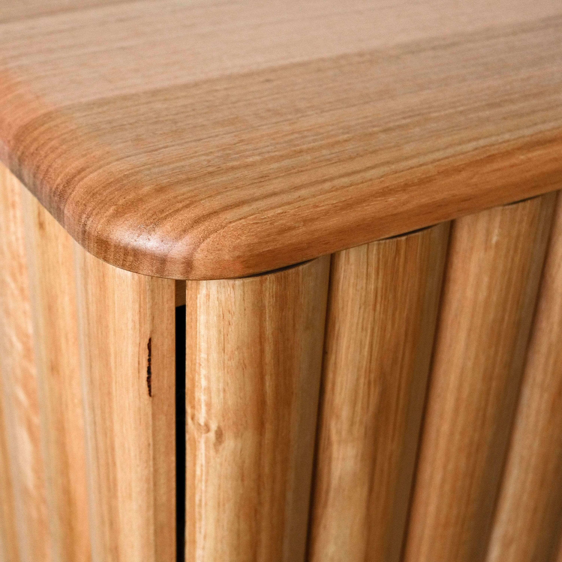 Close-up of a oak cabinet with a slatted design