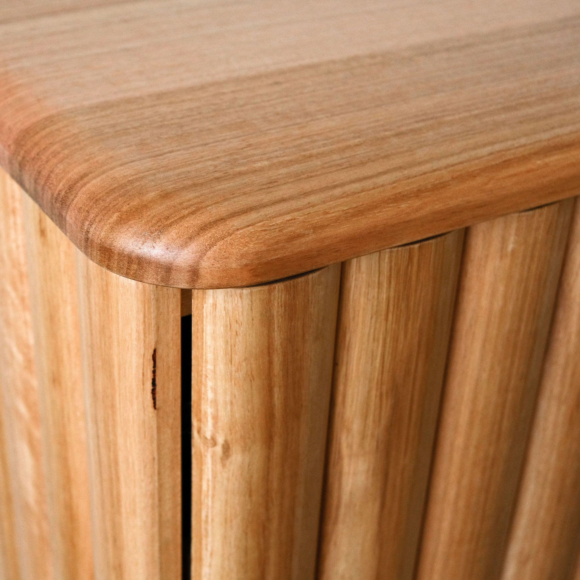 Close-up of a oak sideboard with a slatted design