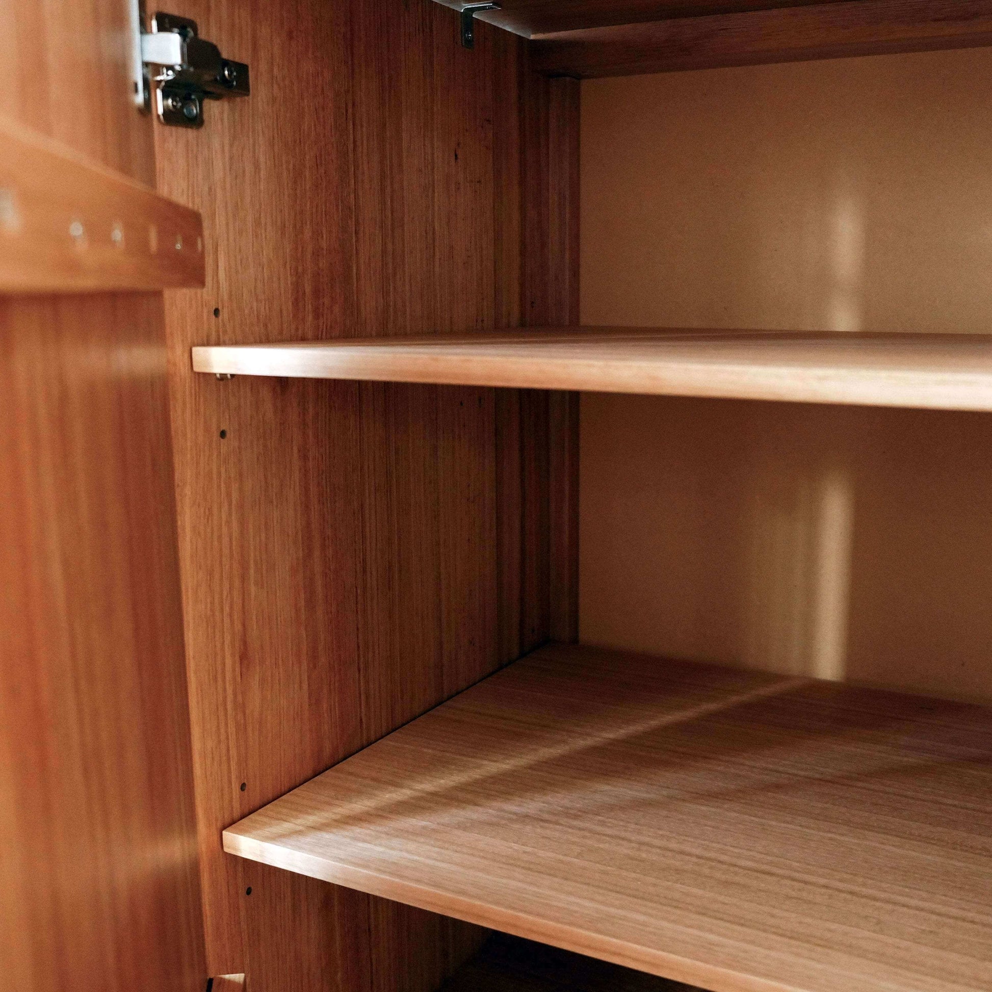 Wooden cabinet with shelves and a hinge
