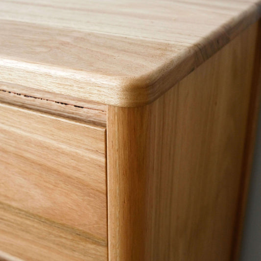 Close-up of a wooden drawer with a light finish