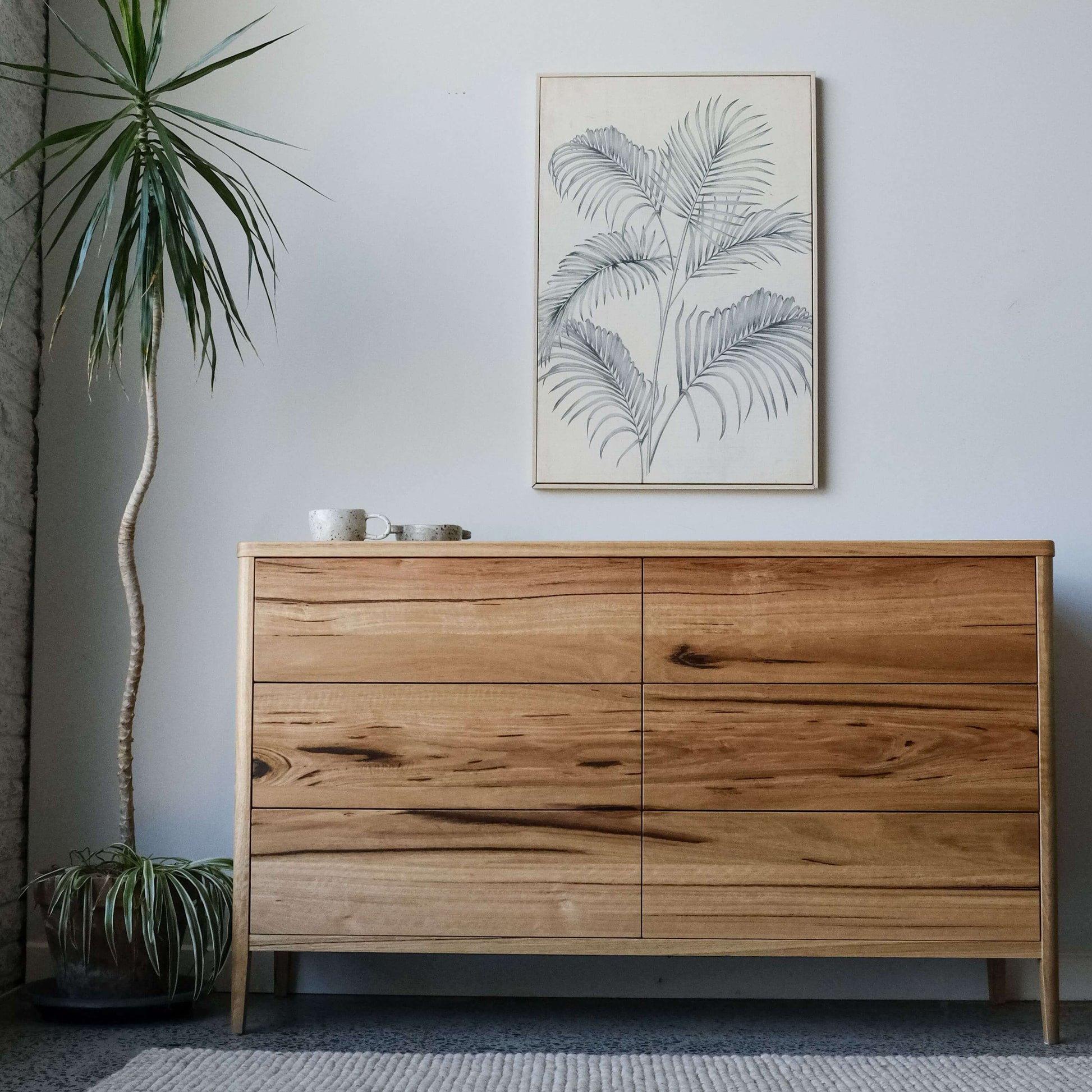 Mayfield sideboard in Wormy Chestnut featuring a modern Scandinavian design with tapered legs.